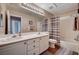 Bathroom with double sinks, a shower-tub combo, and neutral tones create a clean and functional space at 3055 Whispering Crest Dr, Henderson, NV 89052