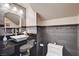 Stylish bathroom featuring gray tiled walls, a granite countertop, and modern vessel sink and faucet at 3055 Whispering Crest Dr, Henderson, NV 89052