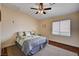 Cozy bedroom with a ceiling fan, natural light from the window, and neutral colored walls at 3055 Whispering Crest Dr, Henderson, NV 89052