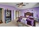 Bright bedroom with purple walls, comfortable bed, and ample natural light from the window at 3055 Whispering Crest Dr, Henderson, NV 89052