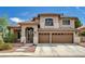 Inviting two-story home featuring a tile roof, three-car garage, and manicured landscaping at 3055 Whispering Crest Dr, Henderson, NV 89052