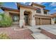Charming two-story home featuring a tile roof, desert landscaping, and a three-car garage at 3055 Whispering Crest Dr, Henderson, NV 89052
