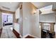 Inviting hallway with hardwood floors, a skylight, and access to a bedroom and dining area at 3055 Whispering Crest Dr, Henderson, NV 89052