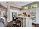 Kitchen with granite island, bar seating and stainless steel appliances; open concept to living space at 3055 Whispering Crest Dr, Henderson, NV 89052