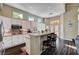 Kitchen with breakfast bar, stainless steel appliances and open floor plan with lots of natural light at 3055 Whispering Crest Dr, Henderson, NV 89052