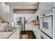 Modern kitchen with stainless steel appliances, tile backsplash, and granite countertops for a sleek design at 3055 Whispering Crest Dr, Henderson, NV 89052