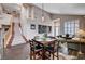Open-concept living area with dining table, stairway and dark floors providing lots of space at 3055 Whispering Crest Dr, Henderson, NV 89052