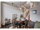 Open-concept living area with dining table, stairway and dark floors providing lots of space at 3055 Whispering Crest Dr, Henderson, NV 89052