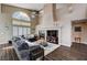 Inviting living room with fireplace, vaulted ceilings, ceiling fan and large windows with lots of natural light at 3055 Whispering Crest Dr, Henderson, NV 89052