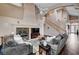 Spacious living room featuring a fireplace, wood floors, high ceilings and staircase to upper level at 3055 Whispering Crest Dr, Henderson, NV 89052