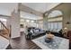 Open concept living room and kitchen area features wood floors, high ceilings, and plenty of light at 3055 Whispering Crest Dr, Henderson, NV 89052