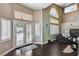 Living room area with double doors to outdoor space with pool, high ceilings and fireplace at 3055 Whispering Crest Dr, Henderson, NV 89052