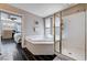 Modern main bathroom with soaking tub, walk-in shower, and access to the main bedroom at 3055 Whispering Crest Dr, Henderson, NV 89052