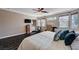 Spacious main bedroom features a ceiling fan, natural light, and wood-look tile floors at 3055 Whispering Crest Dr, Henderson, NV 89052
