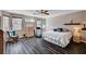 Relaxing main bedroom with ceiling fan, lots of natural light, and wood-look tile floors at 3055 Whispering Crest Dr, Henderson, NV 89052