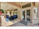 Relaxing covered patio features comfortable seating and views of the sparkling swimming pool and lush outdoor scenery at 3055 Whispering Crest Dr, Henderson, NV 89052