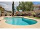 Stunning pool with water feature and lush landscaping, creating a tranquil backyard oasis at 3055 Whispering Crest Dr, Henderson, NV 89052