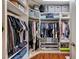 Custom walk-in closet with ample shelving, hanging rods, and storage bins for organization at 3055 Whispering Crest Dr, Henderson, NV 89052