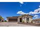 Inviting single-story home featuring a two-car garage, desert landscaping, and charming curb appeal at 314 W Winston Ln, Indian Springs, NV 89018