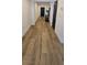 Well-lit hallway with light wood flooring leading to the front door and other rooms at 314 W Winston Ln, Indian Springs, NV 89018