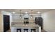 Modern kitchen with a central island, granite countertops, stainless steel appliances, and bar stools at 314 W Winston Ln, Indian Springs, NV 89018