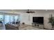 Open living area with a dining area, modern lighting, and neutral decor, with view to the backyard at 314 W Winston Ln, Indian Springs, NV 89018
