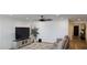 Open living room with modern furniture, large TV, and stylish decor with views to entry door at 314 W Winston Ln, Indian Springs, NV 89018