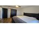 Comfortable main bedroom featuring a decorative barn door and wood flooring at 314 W Winston Ln, Indian Springs, NV 89018