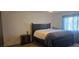 Comfortable bedroom features a large window, stylish decor, and wood flooring at 314 W Winston Ln, Indian Springs, NV 89018