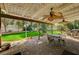 Spacious backyard featuring a covered patio, lush lawn, and volleyball net at 3141 E Katie Ave, Las Vegas, NV 89121