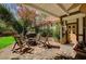 Charming covered patio featuring brick pavers, a fire pit, and comfortable seating at 3141 E Katie Ave, Las Vegas, NV 89121