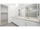 Elegant bathroom featuring double sinks, a large mirror, and a glass-enclosed shower, providing a spa-like experience at 350 Tigullio Ave, Henderson, NV 89011