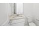 Bathroom featuring a toilet, sink, and mirror at 350 Tigullio Ave, Henderson, NV 89011