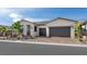 Attractive single-story home with a stone facade, dual garage doors, and neatly landscaped front yard at 350 Tigullio Ave, Henderson, NV 89011