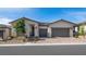 Charming single-story home featuring stone accents, a brick driveway, and a well-maintained front yard at 350 Tigullio Ave, Henderson, NV 89011