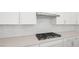 Close-up of a kitchen cooktop and backsplash, offering a modern aesthetic and functional design at 350 Tigullio Ave, Henderson, NV 89011
