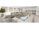Open-concept living area with stylish furnishings, hardwood floors, and a view of the modern kitchen at 350 Tigullio Ave, Henderson, NV 89011