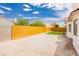Expansive backyard featuring a wood fence, ample space for landscaping, and a clear blue sky overhead at 3630 Daisy Field Dr, North Las Vegas, NV 89032