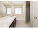 Bright bathroom with double sinks, a tub, and a glass shower at 3630 Daisy Field Dr, North Las Vegas, NV 89032