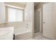 Bright bathroom with tub and tiled shower behind a glass door at 3630 Daisy Field Dr, North Las Vegas, NV 89032