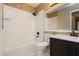 Bathroom featuring a modern vanity, bathtub, shower and unique stone accent at 3630 Daisy Field Dr, North Las Vegas, NV 89032