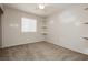 This bedroom has neutral carpet, three corner shelves, and a bright window at 3630 Daisy Field Dr, North Las Vegas, NV 89032