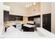 Well-lit kitchen featuring stainless steel appliances, white countertops, and dark wood cabinets at 3630 Daisy Field Dr, North Las Vegas, NV 89032