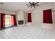 Bright living area boasts a modern fireplace, sliding glass doors, and neutral tile flooring at 3630 Daisy Field Dr, North Las Vegas, NV 89032