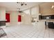 Open-concept living space with tile floors, fireplace, and bar area, flowing into the kitchen at 3630 Daisy Field Dr, North Las Vegas, NV 89032