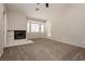 Cozy primary bedroom featuring a fireplace, vaulted ceilings, and an exterior door at 3630 Daisy Field Dr, North Las Vegas, NV 89032
