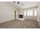 Spacious primary bedroom boasting a cozy fireplace and natural light through the windows at 3630 Daisy Field Dr, North Las Vegas, NV 89032