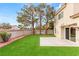 Well-maintained backyard with green lawn, mature trees, and concrete patio, perfect for outdoor entertaining at 3709 Misty Falls St, Las Vegas, NV 89129
