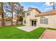 Spacious backyard featuring a lush lawn, mature trees, and a concrete patio area, ideal for relaxation at 3709 Misty Falls St, Las Vegas, NV 89129