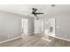 Bright bedroom with hardwood floors, ceiling fan, and ensuite bathroom offers modern comfort at 3709 Misty Falls St, Las Vegas, NV 89129